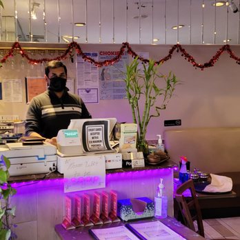 Dosa Delight - a woman behind a counter in a restaurant - Indian Near Me - Jackson Heights, New York Dosa Delight - a woman behind a counter in a restaurant - Indian Near Me - Jackson Heights, New York
