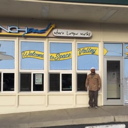 LAUNCHpad - Local muralist extraordinare, David Gutierrez, posing with one of his many masterpieces.