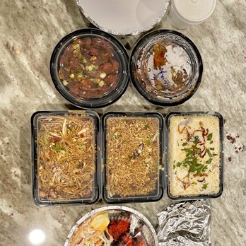 India Garden - a variety of food in plastic containers - Indian Near Me - Garland, Texas