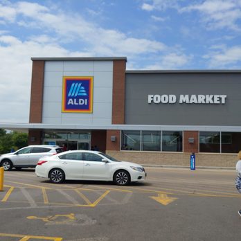 ALDI - a woman pushing a shopping cart in front of a grocery store - Grocery Near Me - Apple Valley, Minnesota