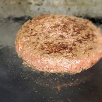 Huck's Cafe - Hand-pattied hamburger on the grill - Burgers Near Me - Commerce, Georgia