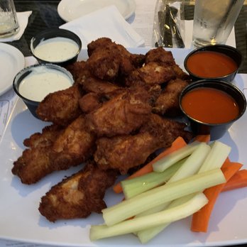 Scoreboard Lounge - a plate of chicken nuggies, carrots, celery, and dipping sauces - Lounges Near Me - Carson, California