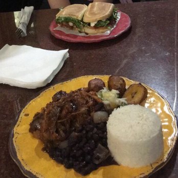 Cafecito - Borracho Pressed Sandwich in the back, GuavaQ Pork Platter up front. - Cuban Near Me - Chicago, Illinois