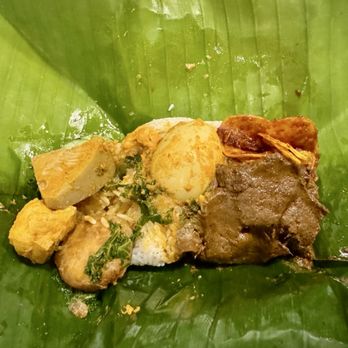 Sumatera Restaurant NYC - Nasi Padang Bungkus- White rice with beef, curry jackfruit, egg, tofu, kale, cucumber, spicy chips, potato fritter and sambal ijo - Indonesian Near Me - Elmhurst, New York Sumatera Restaurant NYC - Nasi Padang Bungkus- White rice with beef, curry jackfruit, egg, tofu, kale, cucumber, spicy chips, potato fritter and sambal ijo - Indonesian Near Me - Elmhurst, New York
