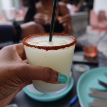 Vals - a person holding a drink with a straw - Seafood Near Me - New Orleans, Louisiana Vals - a person holding a drink with a straw - Seafood Near Me - New Orleans, Louisiana