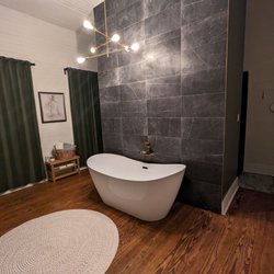 Adeline's Bed and Breakfast - A shared bathroom with freestanding extra large tub and shower area behind the wall.
