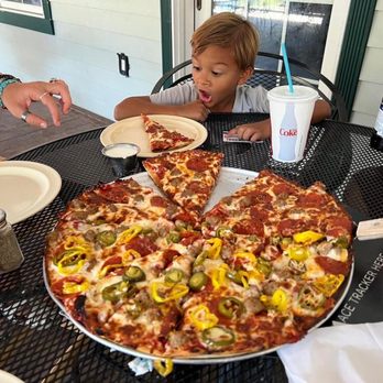 Cruizzers - a young boy sitting at a table with a pizza - Pizza Near Me - Keystone, South Dakota Cruizzers - a young boy sitting at a table with a pizza - Pizza Near Me - Keystone, South Dakota