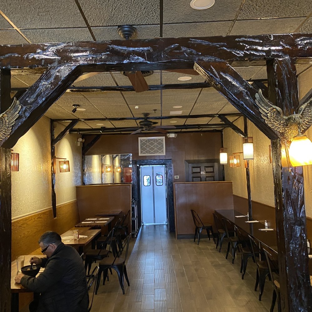 316 Ramen - a man sitting at a table in a restaurant - Ramen Near Me - North Bellmore, New York