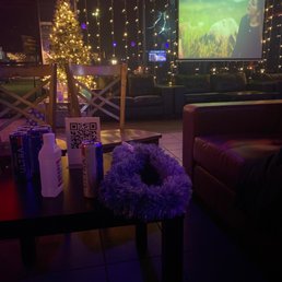 a christmas tree and a movie screen a christmas tree and a movie screen