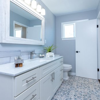 Integrity First Construction - a bathroom with a blue and white tile floor - General Contractors Near Me Integrity First Construction - a bathroom with a blue and white tile floor - General Contractors Near Me