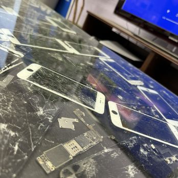 Cheapest iPhone Repair - cool artsy table design made up of phones with broken screens inside - Mobile Phone Repair Near Me - Irvine, California