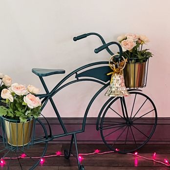 Olenka Peruvian Bistro - a bicycle with a basket of flowers - Bakeries Near Me - Weston, Florida