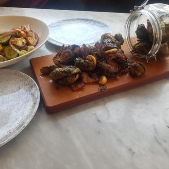 The Collins Small Batch Kitchen - Ceviche with tortilla chips to the left and the roasted brussel sprouts served on a wooden board. All was AMAZING!!! - Bars Near Me - Phoenix, Arizona