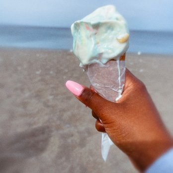 Hutch's On The Beach - a person holding an ice cream cone - Fish & Chips Near Me - Hamilton, Ontario Hutch's On The Beach - a person holding an ice cream cone - Fish & Chips Near Me - Hamilton, Ontario
