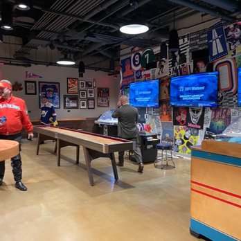 Belmont Hall - a man playing a game of pool - Sports Bars Near Me - Elmont, New York