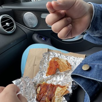 Alicia's Bakery - a person holding a piece of pizza - Bakeries Near Me - New Rochelle, New York Alicia's Bakery - a person holding a piece of pizza - Bakeries Near Me - New Rochelle, New York