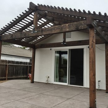 Owen Construction - a patio with a pergolated roof - General Contractors Near Me