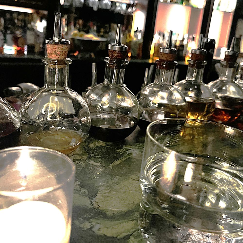 Deep Dive - Cool display of rounded bottles with mysterious liquid inside them - Speakeasies Near Me - Seattle, Washington Deep Dive - Cool display of rounded bottles with mysterious liquid inside them - Speakeasies Near Me - Seattle, Washington