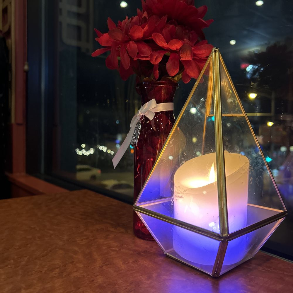 a candle in a glass pyramid a candle in a glass pyramid