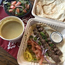 Lunch to go. Lunch portion kefta kabob plate with lentil soup and arugula salad. Less than $20!