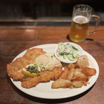 Cafe Rustika - Pork Schnitzel Holstein w/potato and cucumber dill salad - German Near Me - Richmond, Virginia Cafe Rustika - Pork Schnitzel Holstein w/potato and cucumber dill salad - German Near Me - Richmond, Virginia