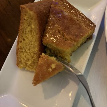 Red Fish Grill - Housemade Cornbread. The edges were drizzled with honey. - Seafood Near Me - New Orleans, Louisiana Red Fish Grill - Housemade Cornbread. The edges were drizzled with honey. - Seafood Near Me - New Orleans, Louisiana