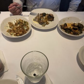 Bonefish Grill - We split the Sea bass, his sides are the new crispy potatoes and the Brussels sprouts. - Seafood Near Me - Longwood, Florida