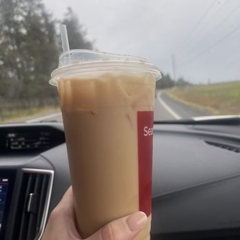 Wild River Java - a hand holding a cup of iced coffee - Coffee & Tea Near Me - McCall, Idaho