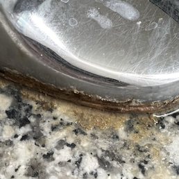 Bacterial biofilm around base of sink faucets. Bacterial biofilm around base of sink faucets.