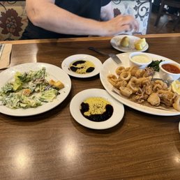 House salad, and calamari appetizer. House salad, and calamari appetizer.