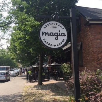 Magia - a restaurant sign in front of a brick building - Italian Near Me - Longueuil, Quebec Magia - a restaurant sign in front of a brick building - Italian Near Me - Longueuil, Quebec