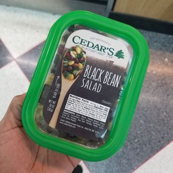 Smoothie King - a hand holding a container of black bean salad - Ice Cream & Frozen Yogurt Near Me - Chicago, Illinois
