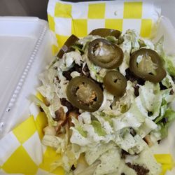 Warped Waffle - The Kirk Fritos, cheese sauce, taco ground beef, lettuce, jalapenos, jalapeno ranch