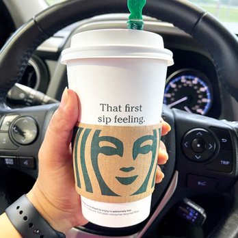 Starbucks - a hand holding a starbucks cup in a car - Coffee & Tea Near Me - Portage, Indiana