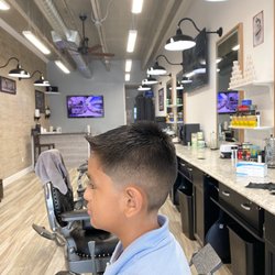 Upper Cuts Barbershop - Half fade on the sides with a skin tape up and a flip in the front