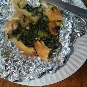 L'Ora Della Pizza - A spinach wheel cut into slices. - Pizza Near Me - New York, New York L'Ora Della Pizza - A spinach wheel cut into slices. - Pizza Near Me - New York, New York