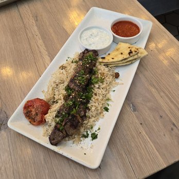 Sadie's - Moroccan Spiced Lamb with Jeweled Basmati Rice, warm Pita, Roasted Tomato along with Tzatziki and Roasted Red Pepper Harissa Sauce. 9/10 - Mediterranean Near Me - Nashville, Tennessee Sadie's - Moroccan Spiced Lamb with Jeweled Basmati Rice, warm Pita, Roasted Tomato along with Tzatziki and Roasted Red Pepper Harissa Sauce. 9/10 - Mediterranean Near Me - Nashville, Tennessee