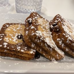 a plate of french toast with powdered sugar