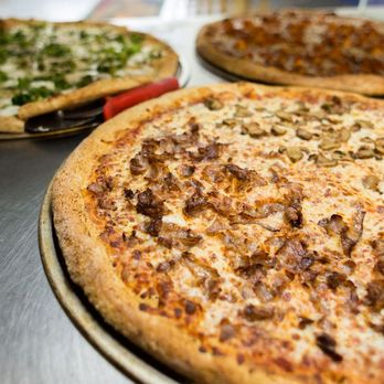 Mick's Pizza - three pizzas on a table - Pizza Near Me - Cohoes, New York