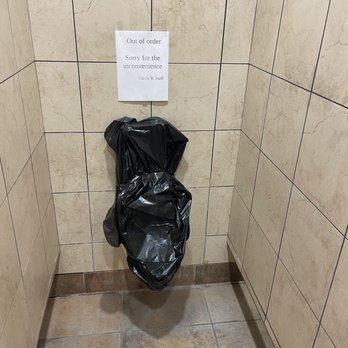 Circle K - Worst bathrooms - A black trash bag is tied to a tiled wall in a restroom, with a sign above it indicating the restroom is out of order. - Gas Stations Near Me - Superior, Arizona
