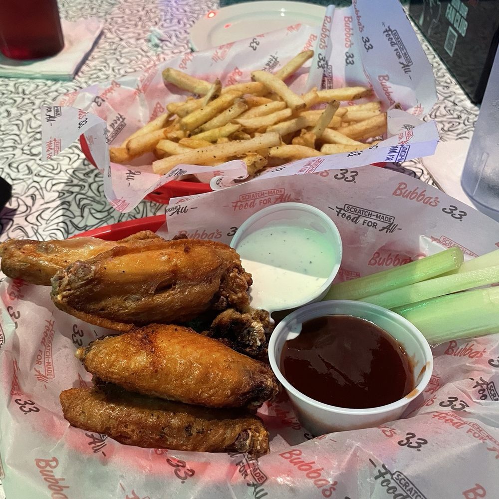 Bubba's 33 - 6 Bubba's Famous Traditional Wings with Raspberry Chipotle sauce and ranch on the side with a basket of fries. - Sports Bars Near Me - Louisville, Kentucky