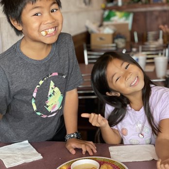 Siam Sunset - Kids eating Chinese donuts with condensed milk. - Thai Near Me - Los Angeles, California Siam Sunset - Kids eating Chinese donuts with condensed milk. - Thai Near Me - Los Angeles, California
