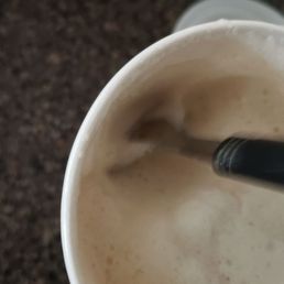 A large chai latte cup filled only 1/3 of the way and covered with foam. A large chai latte cup filled only 1/3 of the way and covered with foam.