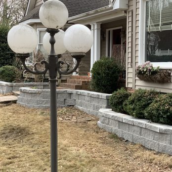 Green X Landscaping - a lamp post in front of a house - Landscaping Near Me