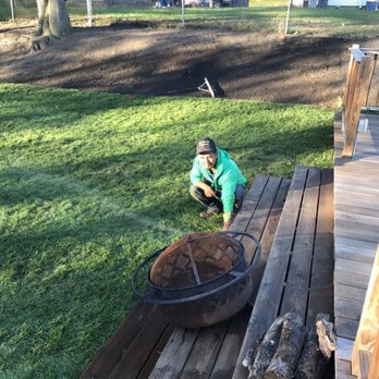 Mendez Irrigation - a boy sitting on a deck with a fire pit - Masonry/Concrete Near Me - Lynn, Massachusetts Mendez Irrigation - a boy sitting on a deck with a fire pit - Masonry/Concrete Near Me - Lynn, Massachusetts