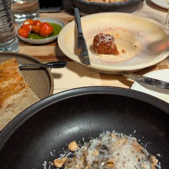 Osteria Il Muro - Mushroom pasta in front, tortellini in the back, and ALL the starters in the middle. - Italian Near Me - Denton, Texas