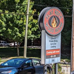 a car parked in front of the sign a car parked in front of the sign