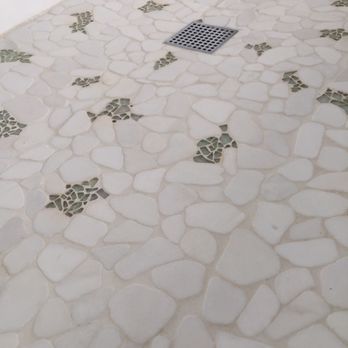 Prestige Installations - 12"x12" marble stone flat river rocks with glass accent pieces on shower floor. - Flooring Near Me