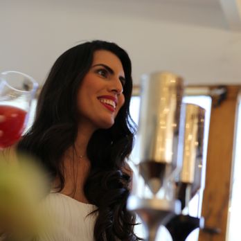 Draft In Style - a woman in a white dress sitting at a table - Party & Event Planning Near Me Draft In Style - a woman in a white dress sitting at a table - Party & Event Planning Near Me