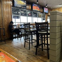 Hooters - Floors sticky and employee just sitting doing nothing. 1 waitress for entire floor....